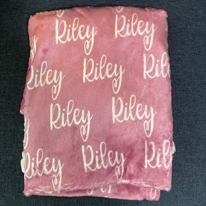Personalized pink baby blanket with “Riley”